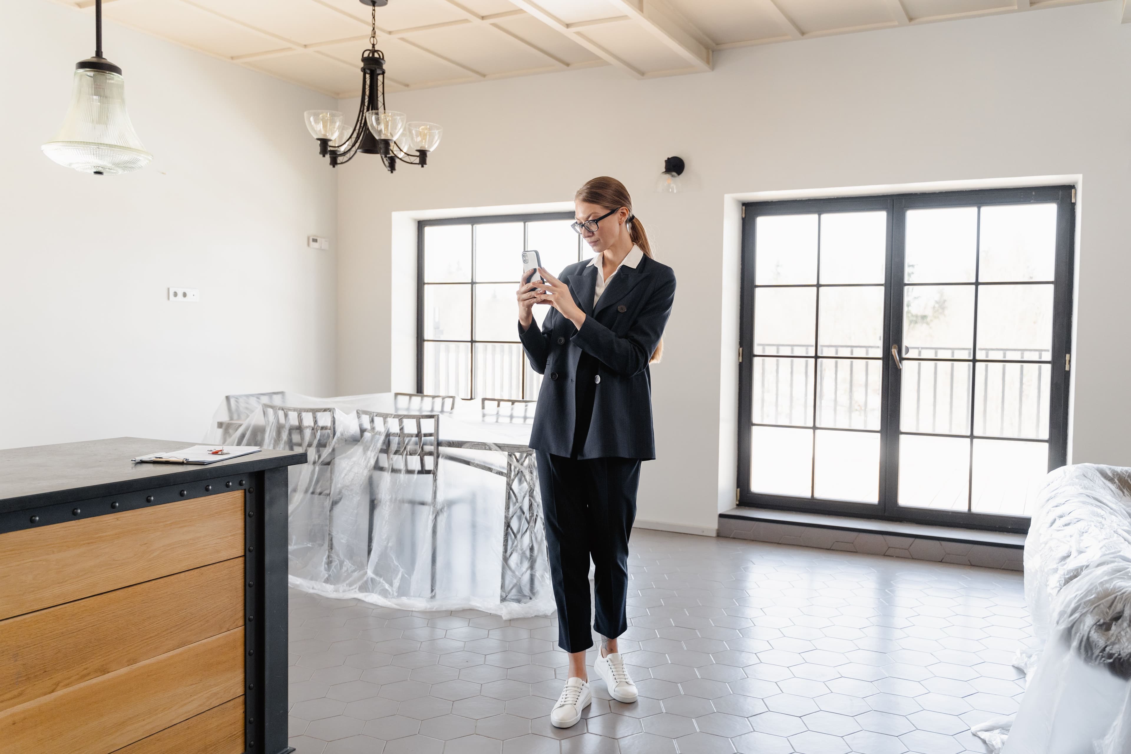 Property professional capturing a room on a smartphone